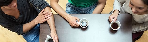 Stock image of friends talking at the coffee shop