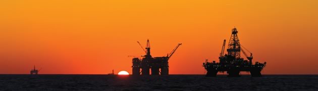 Stock image of drilling rigs silhouette at sunset 
